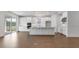 Bright, open kitchen with white cabinets, stainless steel appliances, large island, and sliding glass doors at 4192 Barbuda Ln, Kissimmee, FL 34758