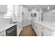 Modern kitchen with white cabinets, stainless steel appliances, and a large island with a marble countertop at 4192 Barbuda Ln, Kissimmee, FL 34758