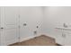 Well-lit laundry room with tile floor and sink at 4192 Barbuda Ln, Kissimmee, FL 34758