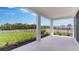 Covered patio overlooking a lush, green lawn at 4192 Barbuda Ln, Kissimmee, FL 34758