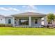 Lush backyard with a covered patio perfect for outdoor entertaining and a beautiful lawn at 4198 Barbuda Ln, Kissimmee, FL 34758