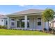 Grassy backyard featuring a covered patio with outdoor seating area at 4198 Barbuda Ln, Kissimmee, FL 34758
