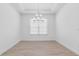 Bright dining room with contemporary chandelier fixture and large window at 4198 Barbuda Ln, Kissimmee, FL 34758