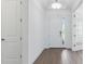 Inviting foyer with wood-look tile flooring, white walls, and a front door with sidelight at 4198 Barbuda Ln, Kissimmee, FL 34758
