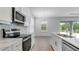Bright kitchen with stainless steel appliances, white cabinets, quartz countertops, and stylish backsplash, great for cooking and entertaining at 4198 Barbuda Ln, Kissimmee, FL 34758