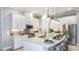 Bright kitchen with stainless steel appliances, quartz counters, white cabinets, and pendant lighting at 4198 Barbuda Ln, Kissimmee, FL 34758