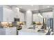 Bright kitchen with stainless steel appliances, quartz counters, white cabinets, and pendant lighting at 4198 Barbuda Ln, Kissimmee, FL 34758
