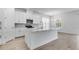 Open kitchen featuring an island with quartz countertops, stainless steel appliances, modern fixtures, and white cabinetry at 4198 Barbuda Ln, Kissimmee, FL 34758