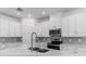 Modern kitchen features stainless steel appliances, quartz countertops, subway tile backsplash, and ample white cabinetry for storage at 4198 Barbuda Ln, Kissimmee, FL 34758