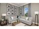 Stylish living room features a modern sofa, curated artwork, and plenty of natural light at 4198 Barbuda Ln, Kissimmee, FL 34758