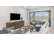 Cozy living room with modern furniture, sliding glass doors to a screened lanai and stylish decor at 4198 Barbuda Ln, Kissimmee, FL 34758