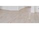 Spacious open floor plan showcasing light wood-look tile flooring, neutral walls, and an abundance of natural light at 4198 Barbuda Ln, Kissimmee, FL 34758