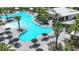 Aerial view of a community pool surrounded by palm trees, lounge chairs, and the Bahama Bar at 4198 Barbuda Ln, Kissimmee, FL 34758