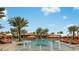 Large community pool featuring water fountains, palm trees, and comfortable lounge chairs at 4198 Barbuda Ln, Kissimmee, FL 34758