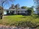 Charming single-story home with carport and lush green lawn at 4202 Mizell St, Orlando, FL 32812