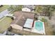 An aerial view displays a home with a basketball court and pool, set within a maturely landscaped backyard at 453 Weathersfield Ave, Altamonte Springs, FL 32714