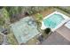 An aerial view showcasing a basketball court, pool, and tree coverage of the home's backyard at 453 Weathersfield Ave, Altamonte Springs, FL 32714
