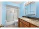 Bright bathroom featuring a granite countertop vanity and combined bath and shower at 453 Weathersfield Ave, Altamonte Springs, FL 32714