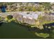 Aerial view of complex with water view and parking, surrounded by lush greenery and landscaping at 4575 S Texas Ave # 205, Orlando, FL 32839