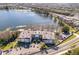 Stunning aerial view of lakeside apartments, showcasing the building, surrounding trees, and ample parking at 4575 S Texas Ave # 205, Orlando, FL 32839