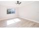 Bright, unfurnished bedroom features wood-look floors and a window with outside views at 4575 S Texas Ave # 205, Orlando, FL 32839