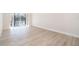 Bright, unfurnished bedroom features wood-look floors and access to a patio with lake views at 4575 S Texas Ave # 205, Orlando, FL 32839