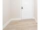 Clean entryway featuring neutral paint, light wood floors and a white front door at 4575 S Texas Ave # 205, Orlando, FL 32839