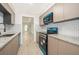 Well-lit kitchen featuring granite countertops, stainless steel appliances and subway tile at 4575 S Texas Ave # 205, Orlando, FL 32839