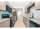 Well-lit kitchen featuring granite countertops, stainless steel appliances, and white subway tile backsplash at 4575 S Texas Ave # 205, Orlando, FL 32839