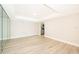 Open-concept living room with wood floors, recessed lighting, and a mirrored wall at 4575 S Texas Ave # 205, Orlando, FL 32839