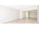 Open-concept living space with light wood floors, neutral walls, and a view to the hallway at 4575 S Texas Ave # 205, Orlando, FL 32839