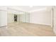 The living room features an open layout, wood flooring, and a mirrored wall at 4575 S Texas Ave # 205, Orlando, FL 32839