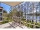 Enjoy serene lake views from this screened patio with stone flooring at 4575 S Texas Ave # 205, Orlando, FL 32839