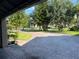 Brick driveway leading to a home surrounded by well-maintained landscaping and mature trees in a quiet neighborhood at 4847 Lake Milly Dr, Orlando, FL 32839