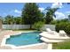 Backyard pool area surrounded by lush landscaping, brick patio, and privacy fence at 4847 Lake Milly Dr, Orlando, FL 32839