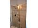 Modern shower with tiled walls, glass door, and bronze fixtures, offering a spa-like experience at 4847 Lake Milly Dr, Orlando, FL 32839