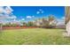 Large, grassy backyard enclosed by a brick and wood fence, perfect for outdoor activities at 5071 Heatherstone Dr, Kissimmee, FL 34758