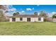 Spacious backyard featuring a green lawn, a modest patio and a wooden fence at 5071 Heatherstone Dr, Kissimmee, FL 34758