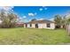 View of the home's backyard featuring a large, grassy area and enclosed wooden fence at 5071 Heatherstone Dr, Kissimmee, FL 34758