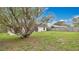 The property boasts a large backyard with a mature tree and a wood fence at 5071 Heatherstone Dr, Kissimmee, FL 34758