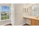 Bathroom with vanity, sink, and a window to view exterior at 5071 Heatherstone Dr, Kissimmee, FL 34758