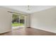 Bright dining room with wood floors and sliding glass doors to the backyard at 5071 Heatherstone Dr, Kissimmee, FL 34758