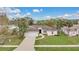 Well-maintained home with a two-car garage, mature landscaping, and a welcoming entrance at 5071 Heatherstone Dr, Kissimmee, FL 34758