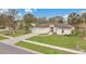 Charming home featuring a well-manicured lawn, mature landscaping, and an attached two-car garage at 5071 Heatherstone Dr, Kissimmee, FL 34758