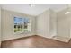 Bright living room features sleek wood floors and a large window overlooking a beautifully landscaped yard at 5071 Heatherstone Dr, Kissimmee, FL 34758