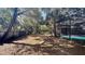 Large, leaf-covered backyard with a screened pool, offering privacy and room to roam at 5200 Brosche Rd, Orlando, FL 32807