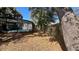 Backyard featuring a screened pool and mature trees, enhancing the property's outdoor living experience at 5200 Brosche Rd, Orlando, FL 32807