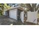 Side view of the home showing the garage, with a fenced walkway and gate to the backyard at 5200 Brosche Rd, Orlando, FL 32807