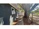 View of the side of the house with a large tree next to the window and white fenced-in yard in the background at 5200 Brosche Rd, Orlando, FL 32807