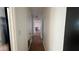 Hallway with tile flooring leading to a brightly lit living space, adding depth and openness to the home's layout at 5200 Brosche Rd, Orlando, FL 32807